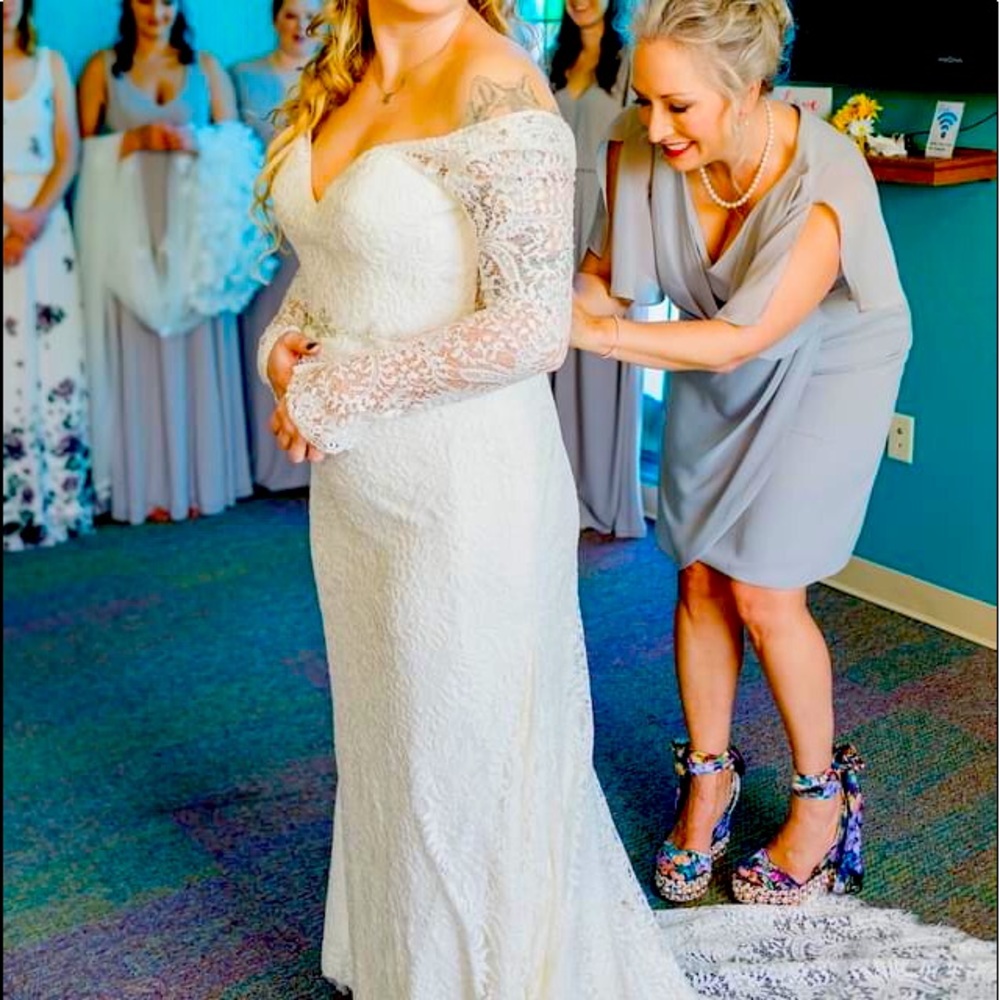 Beautiful long sleeved open plunge back wedding dress in ivory.